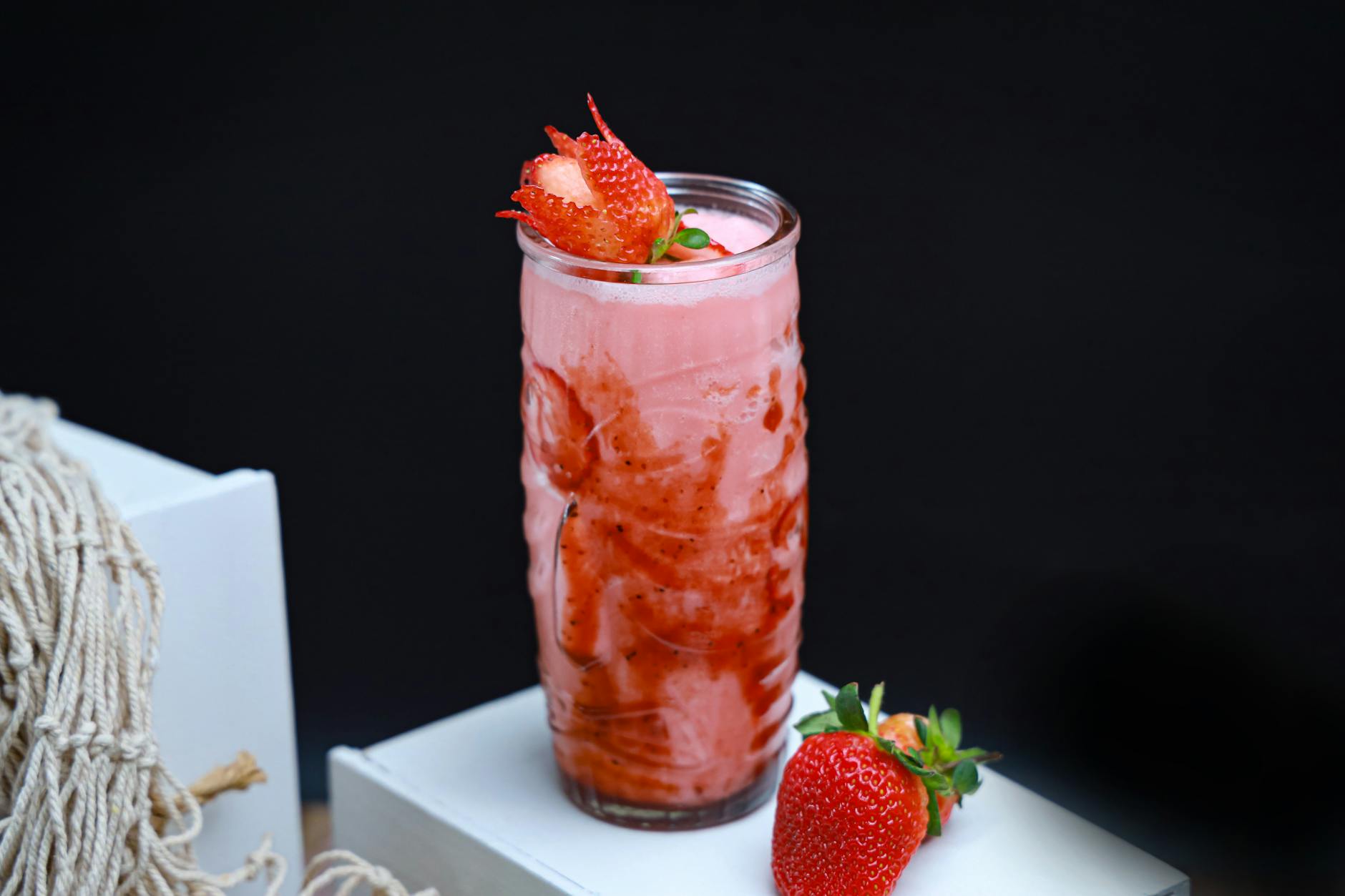 A vibrant strawberry smoothie topped with fresh fruit, perfect for a healthy lifestyle.